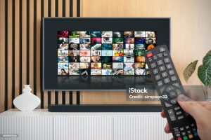 person using tv remote