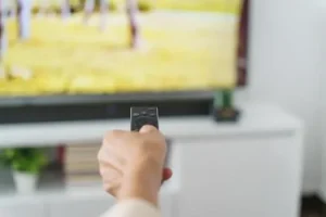 person using tv remote